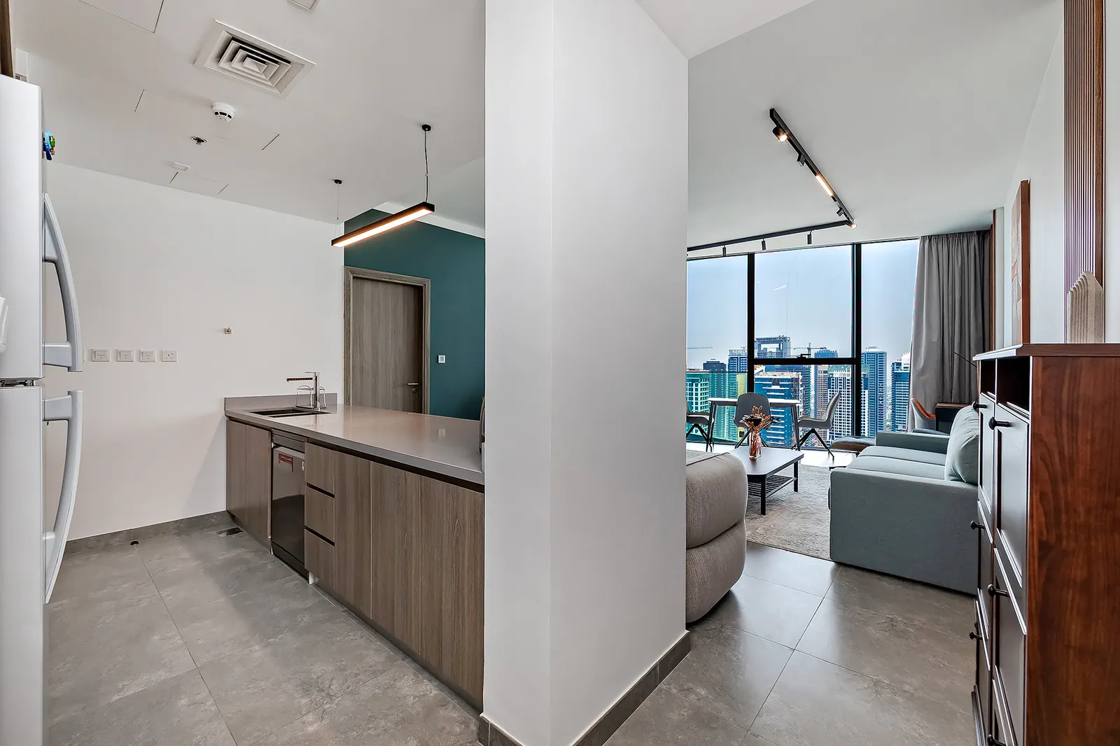 Living room with a panoramic window in a Stellium apartment, Dubai Marina